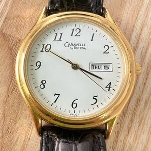 Caravelle by Bulova mens gold tone black leather dress watch NEW BATTERY